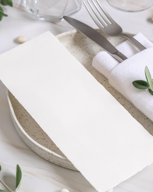 Cadre de table élégant avec une carte décorée de branches d'eucalyptus en gros plan Maquette de mariage