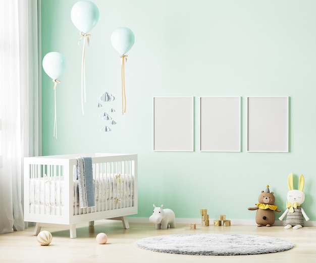 Cadres d'affiche vierges sur mur vert en fond intérieur de chambre d'enfant avec literie pour bébé