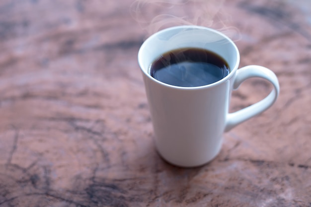 Café chaud dans une tasse blanche sur la table