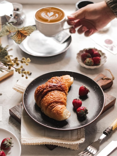 Photo café et croissant sur la table petit-déjeuner français