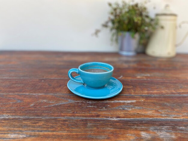 Café dans une tasse bleue sur une table en bois