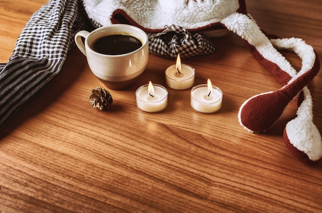 Le Café En Hiver Est Une Décoration Avec Une écharpe, Un Chapeau, Des Bougies Et Du Pin Sur La Table En Bois. Tonalité De Couleur Chaude.