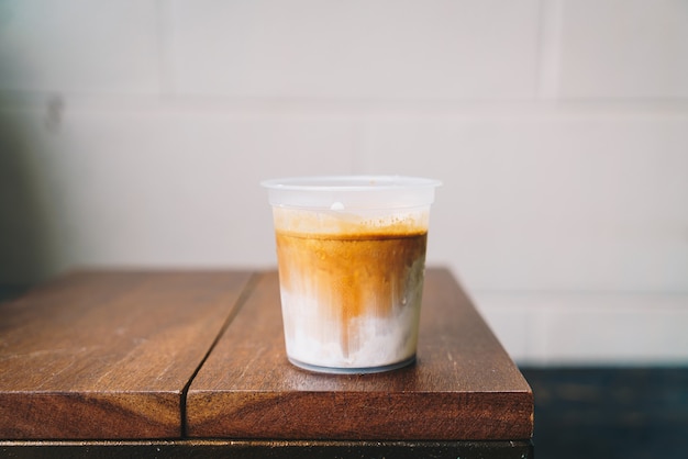 Café sale en verre à emporter sur table en bois