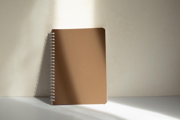 Cahier d'école sur fond blanc, bloc-notes en spirale sur une table. mise à plat