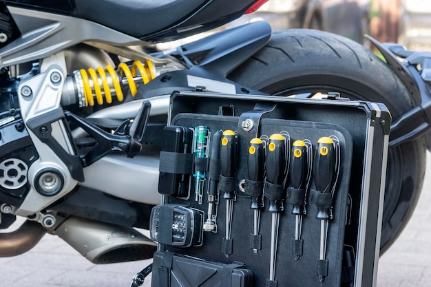 Une caisse d'instruments techniques debout à côté de la moto