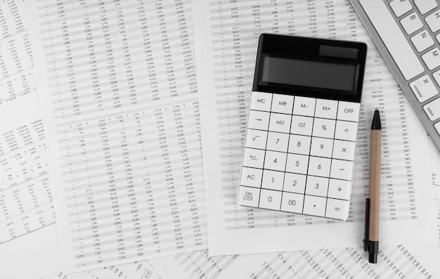 Calculatrice près d'un ordinateur portable sur les états financiers Vue de dessus