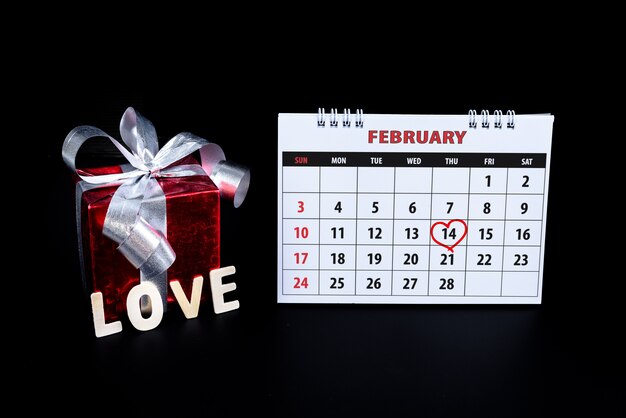 Calendrier avec main rouge écrite le coeur met en évidence le 14 Février de Saint Valentin