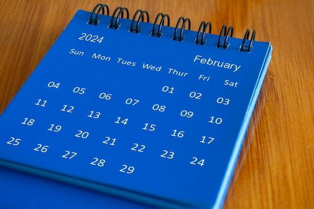 Photo calendrier de table de février 2024 sur un bureau en bois concept de temps et de calendrier