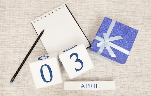 Calendrier avec texte et chiffres bleus tendance pour le 3 avril et un cadeau dans une boîte.