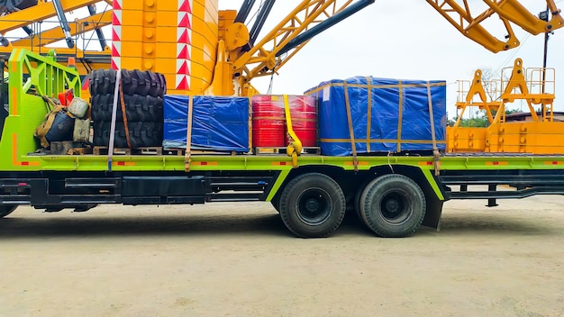 Un camion cargo chargé de pneus, de tambours et de caisses-palettes.