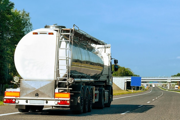 Camion avec stockage de liquide ou d'huile sur route ou autoroute de Pologne. Camion avec citerne de service-citerne au travail logistique. Citerne semi-remorque. Conduite de voiture de fret. Livraison de fret. Industrie des transports à l'exportation