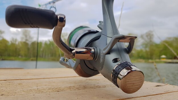 Canne à pêche à la carpe isolée sur le lac et pont en bois