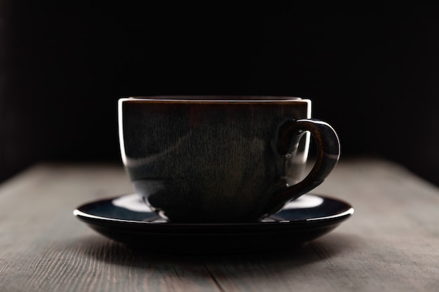 Photo cappuccino dans une tasse de café sur fond sombre