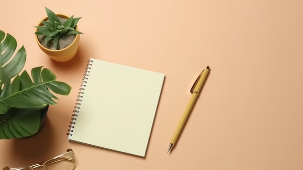 Un carnet, un stylo et une plante sur une table