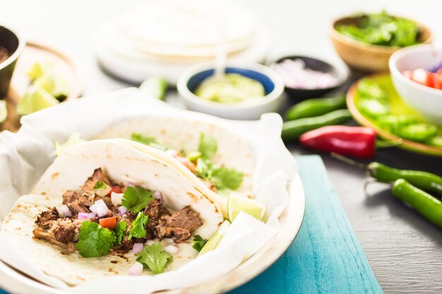 Carnitas de porc effiloché avec pico de gallo sur une tortilla de farine.