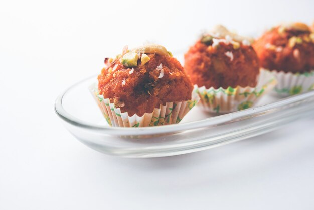 Carotte Halwa Laddu ou boules sucrées, servies dans une assiette avec des garnitures de fruits secs. mise au point sélective