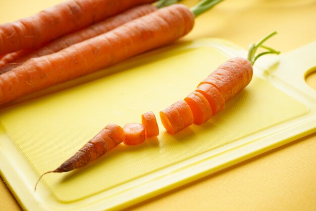 Carottes fraîchement tranchées en tranches sur planche de cuisine à découper