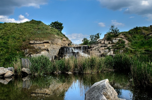 Carrière industrielle de granit inondée avec cascades