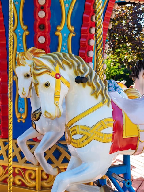 Carrousel avec chevaux blancs dans un parc de vacances