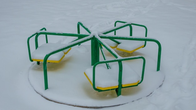 Carrousel pour enfants en hiver sous la neige.