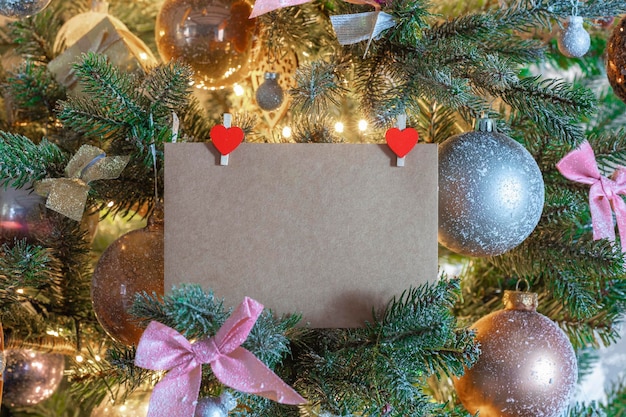 Carte de Noël vierge ou invitation dans un sapin de Noël décoré. Espace pour la copie. Maison de vacances, cadeau, espace de concept de fond présent pour le texte