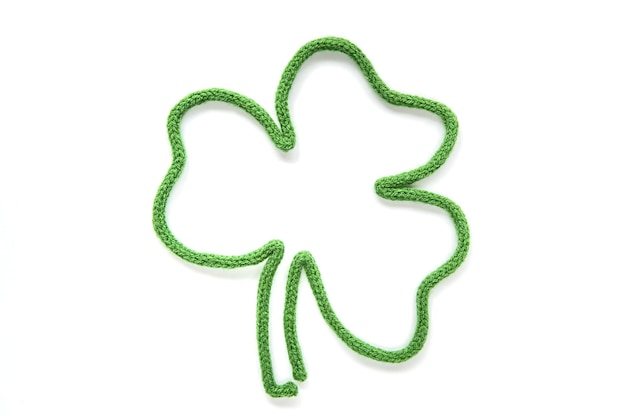 Carte de voeux St Patricks Day Emblème de trèfle à feuilles sur une surface blanche. Vue de dessus Espace de copie