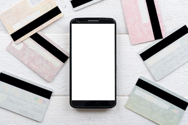 Photo cartes de crédit et smartphone allongé sur une table en bois