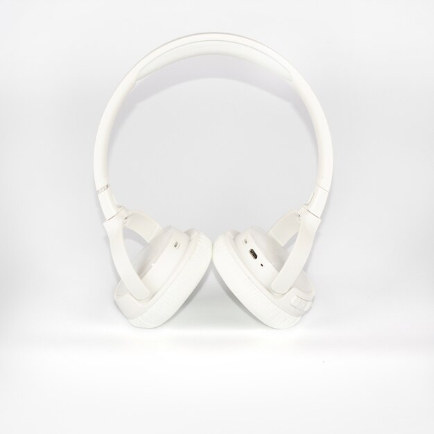 Casque sans fil blanc sur fond blanc.