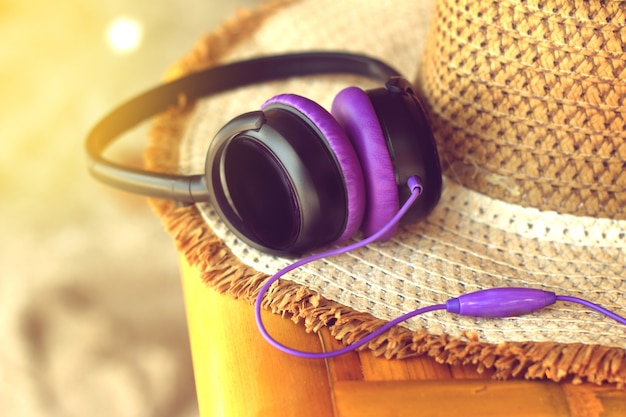 Photo casque violet, couché au chapeau de paille