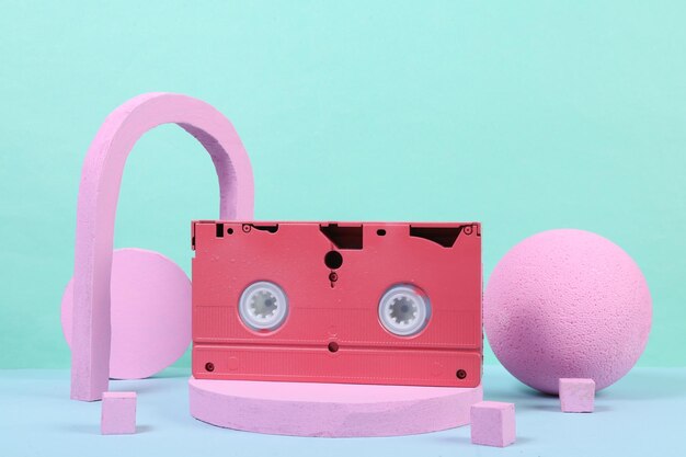 Cassette vidéo rose sur le podium avec des shapas géométriques Concept art Mode Minimalisme