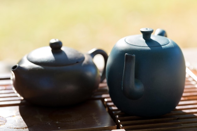 Cérémonie chinoise du thé Théière en céramique faite d'argile et de bols sur un fond en bois