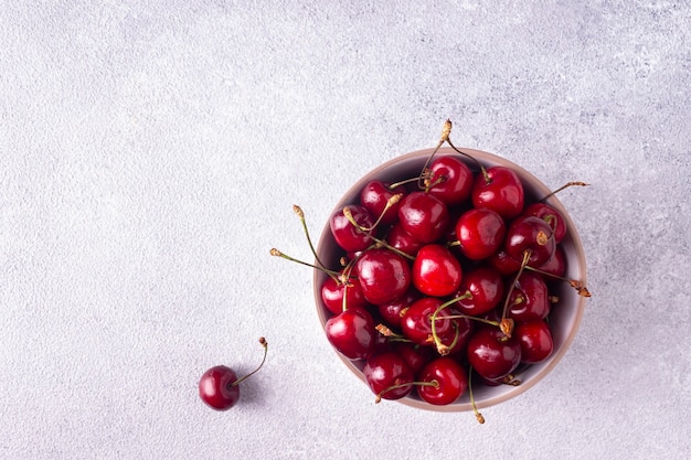 Cerises dans une assiette blanche ronde à plat