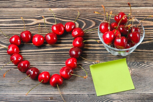 Cerises dans la coupe sur une table en bois