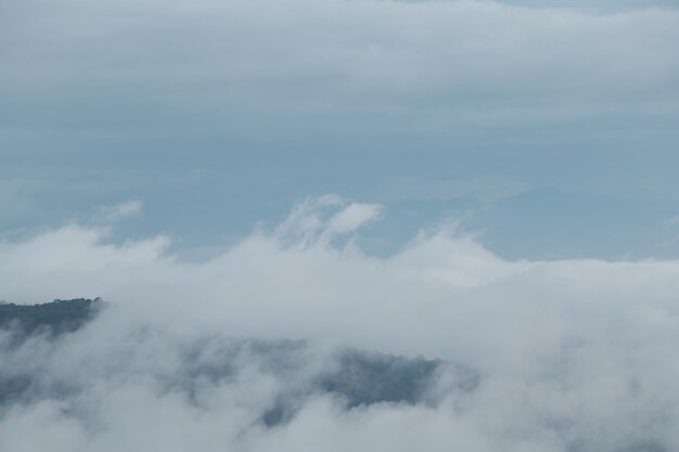 Chaîne de montagnes avec des silhouettes visibles à travers le brouillard bleu du matin