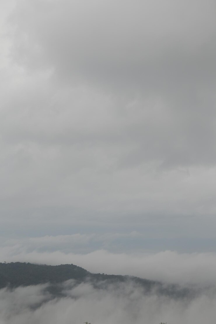 La chaîne de montagnes avec des silhouettes visibles à travers le brouillard bleu du matin