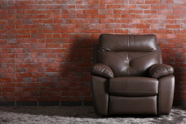Photo une chaise en cuir brun sur un fond de mur de brique