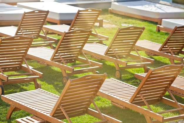 Chaises au bord de la piscine de l'hôtel sur un pré vert