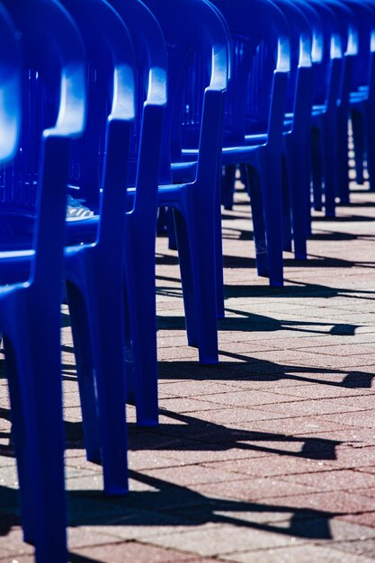 Photo des chaises en plastique vides lumineuses se tiennent dans une rangée la place des attentes du public