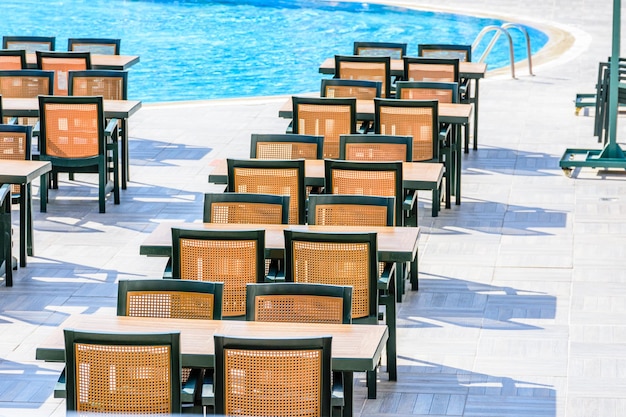 Chaises et tables dans un café de rue confortable près de la piscine