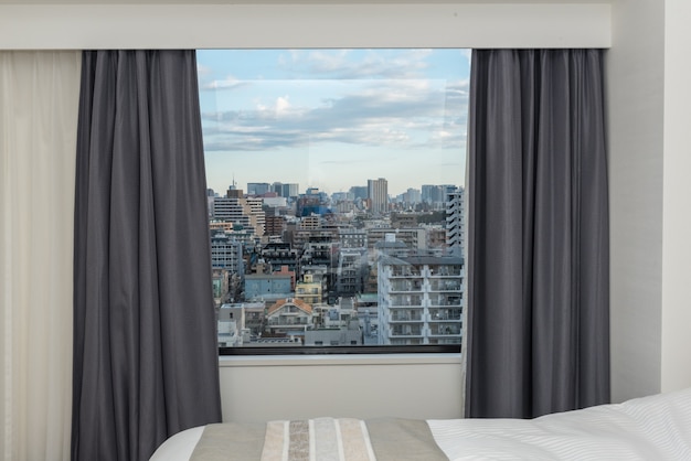 Chambre à coucher avec fenêtre rideau et cité