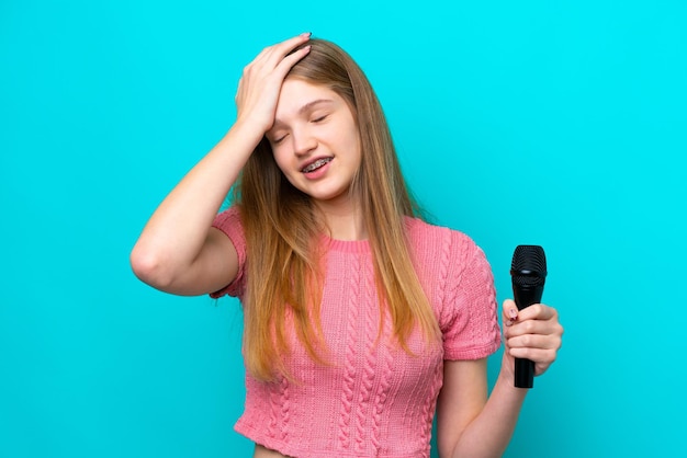 La chanteuse russe qui prend un microphone isolé sur fond bleu a réalisé quelque chose et a l'intention de trouver la solution