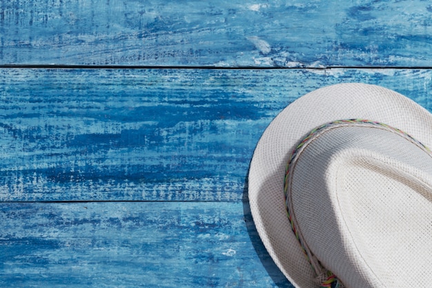 Chapeau d'été sur la table en bois bleue