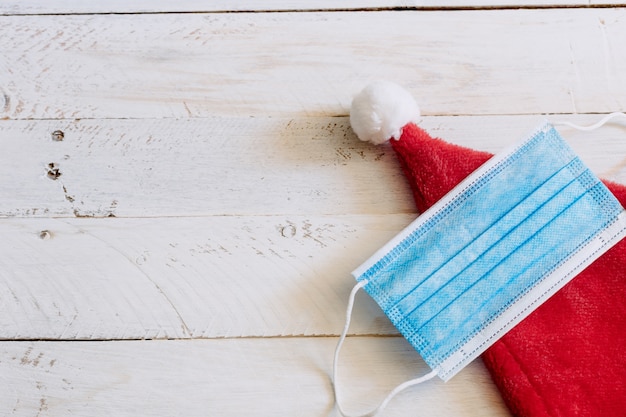 Chapeau de père Noël avec masque sur table en bois