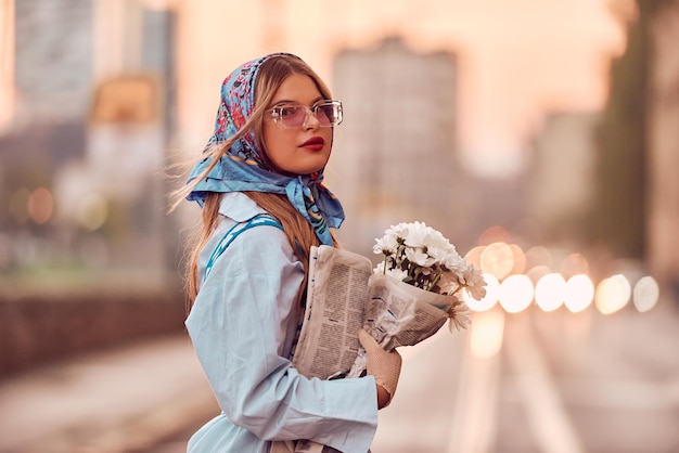 Photo charme d'une femme parée d'une robe traditionnelle bleue exquise portant un sac à main bleu et un