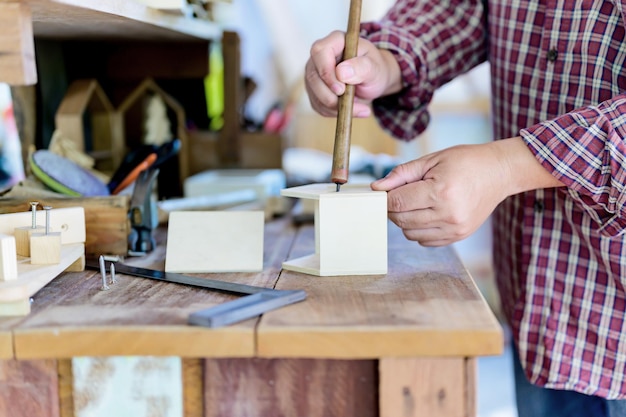 Charpentier travaillant dans un atelier de menuiserie. Boiseries pour le concept de fabrication de meubles et de décoration intérieure. Bois de bricolage pour la décoration.