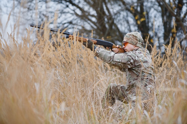 Chasseur en uniforme avec un fusil de chasse