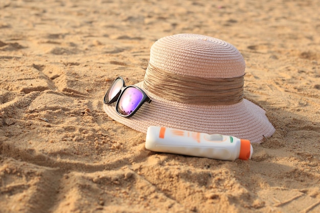 chaud et lunettes sur le sable en mer