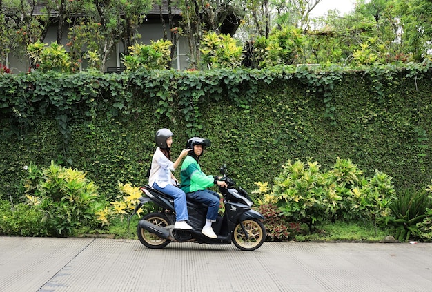 Des chauffeurs de moto-taxi en ligne avec des passagers féminins