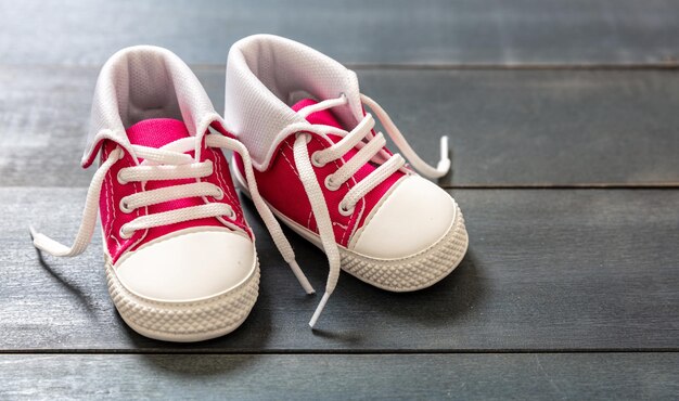 Chaussures bébé fille rose sur fond de couleur bleu vue rapprochée