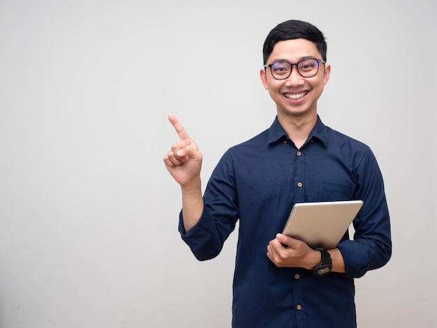 Cheerful businessman holding tablet sourire pointer du doigt l'espace de copie